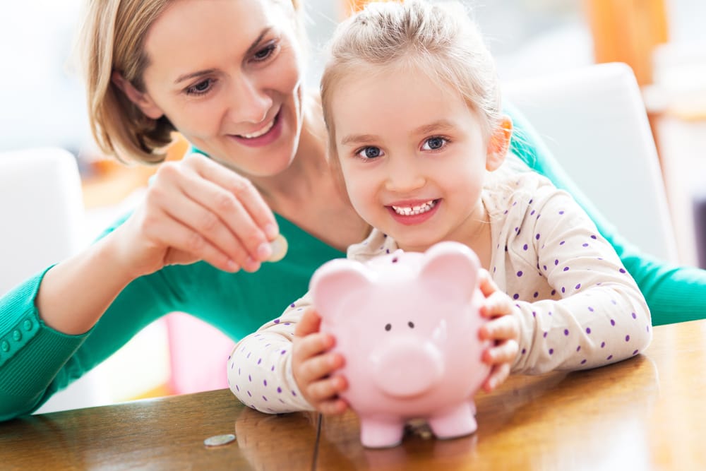mother and child using piggy bank to save for financial incentives
